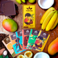 Image of six brightly-colored chocolate bars with bright yellow gift box and tropical fruits