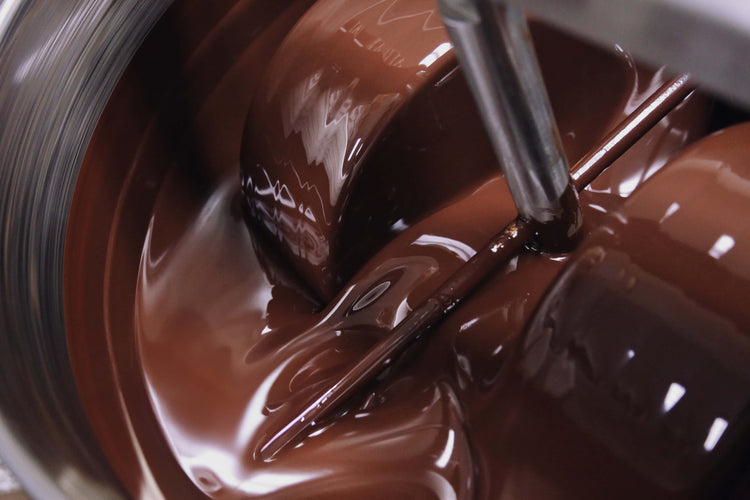 Image of liquid chocolate grinding in machine