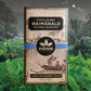 Image of Waimanalo chocolate bar in brown, natural-looking packaging, over tropical forest background