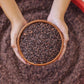 Image of person holding bowl of cacao nibs